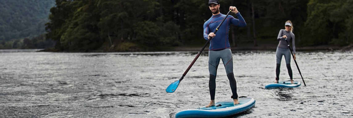 Homme et femme sur un paddle avec un tshirt manche longue et un pantalon anti UV